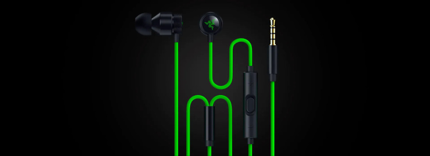 Black wired earphones with green cable, in-ear buds, inline controls, and 3.5mm jack on a black background.